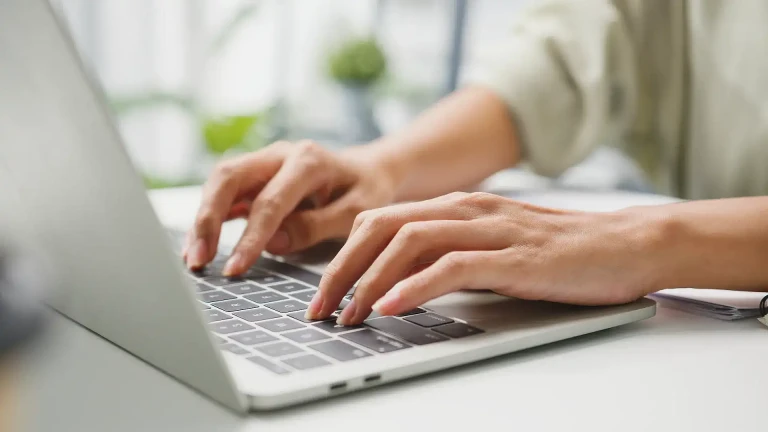 Typing on laptop