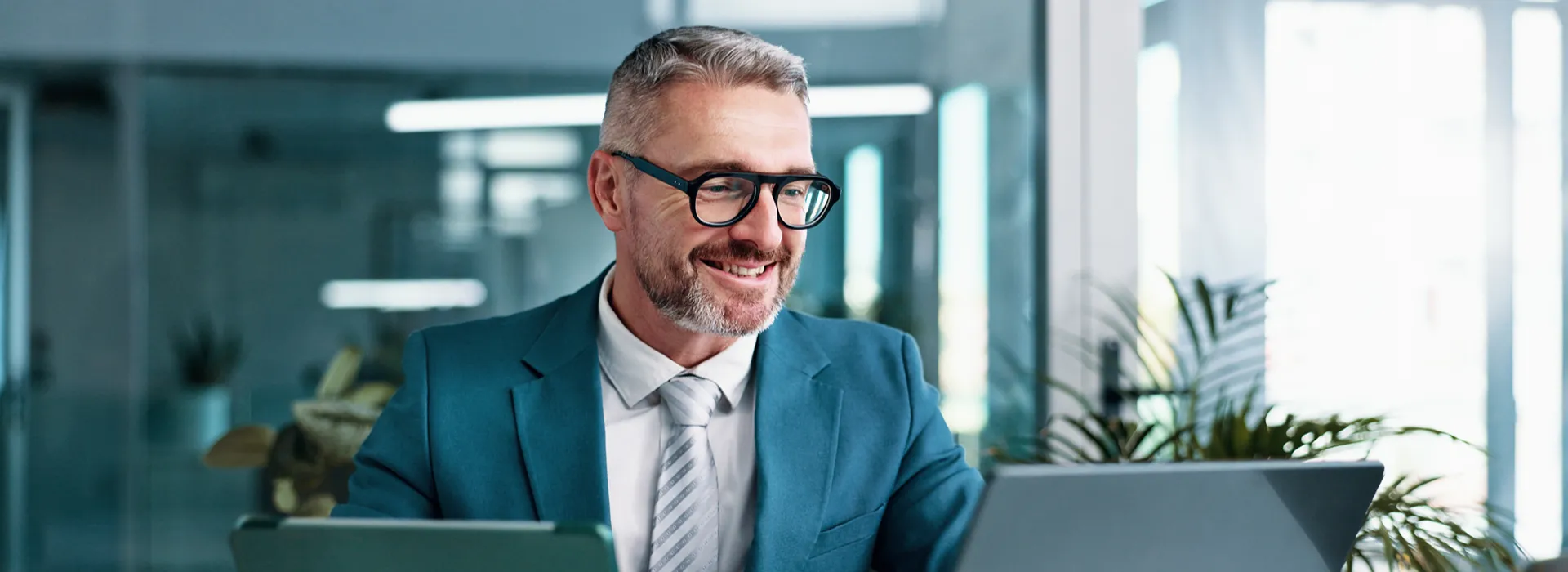 Businessman with tablet and laptop