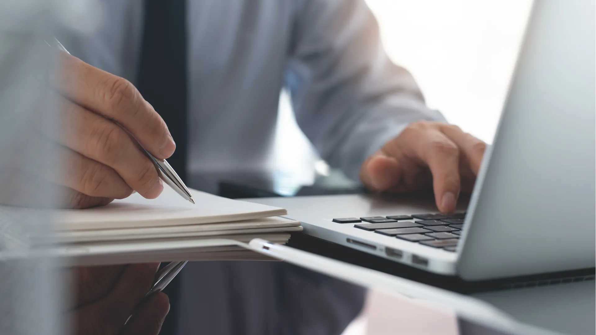Businessman with laptop and notebook